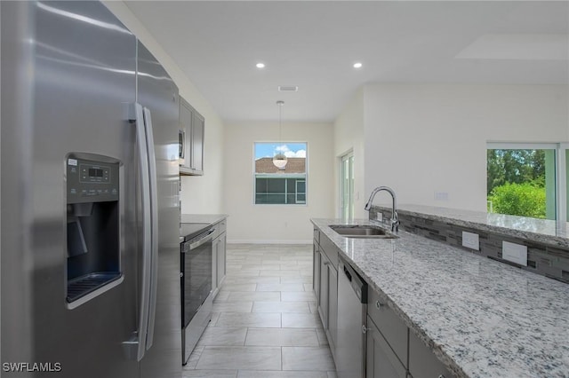 311 Rand Ave, Lehigh Acres, FL 33974 - kitchen featuring appliances with stainless steel finishes, light stone countertops, recessed lighting, decorative light fixtures, and gray cabinetry
