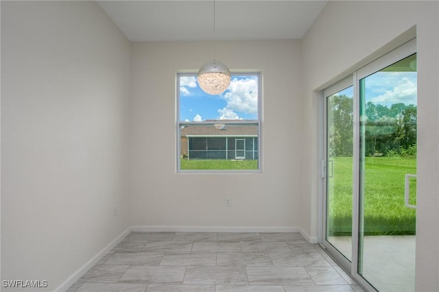 311 Rand Ave, Lehigh Acres, FL 33974 - unfurnished dining area with light marble finish floors and baseboards