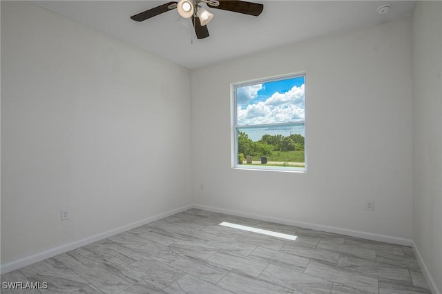 311 Rand Ave, Lehigh Acres, FL 33974 - spare room with a ceiling fan and baseboards