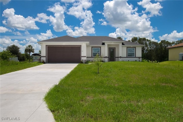 311 Rand Ave, Lehigh Acres, FL 33974 - prairie-style house with an attached garage, driveway, stucco siding, and a front lawn