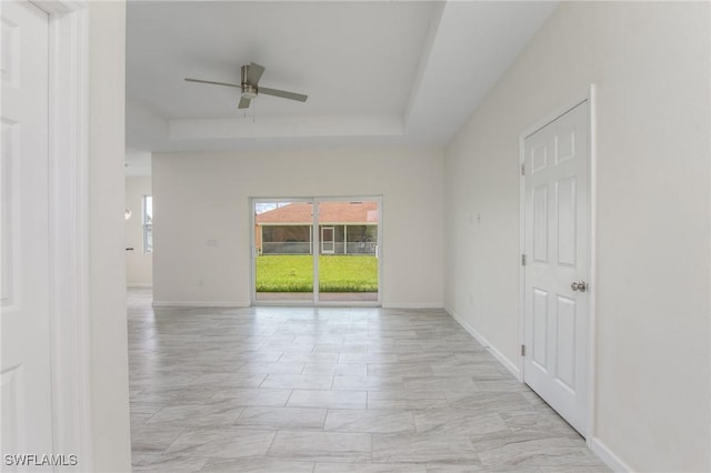 311 Rand Ave, Lehigh Acres, FL 33974 - spare room featuring a ceiling fan and a tray ceiling