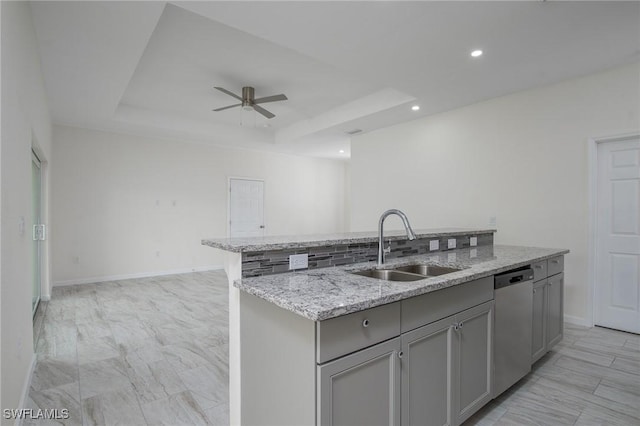 311 Rand Ave, Lehigh Acres, FL 33974 - kitchen with stainless steel dishwasher, a center island with sink, a ceiling fan, gray cabinets, and light stone counters