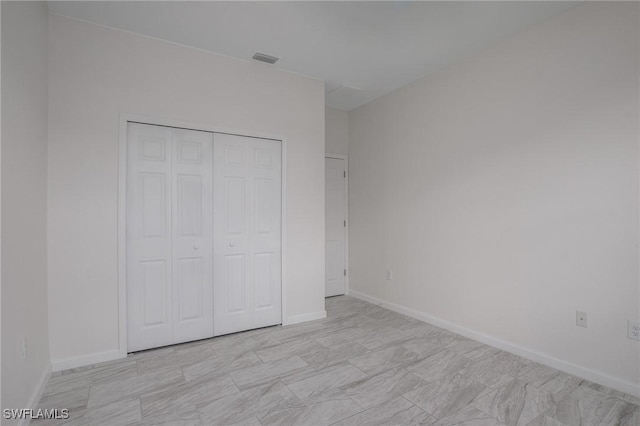 311 Rand Ave, Lehigh Acres, FL 33974 - unfurnished bedroom with a closet and baseboards