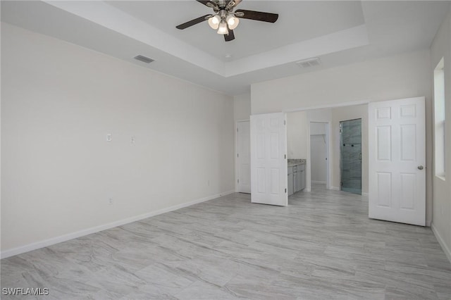311 Rand Ave, Lehigh Acres, FL 33974 - unfurnished bedroom featuring a raised ceiling and a ceiling fan