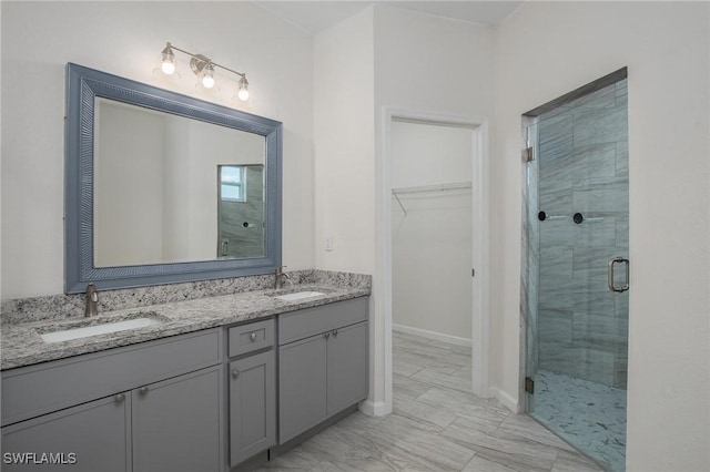 311 Rand Ave, Lehigh Acres, FL 33974 - bathroom with a shower stall, double vanity, a walk in closet, and marble finish flooring