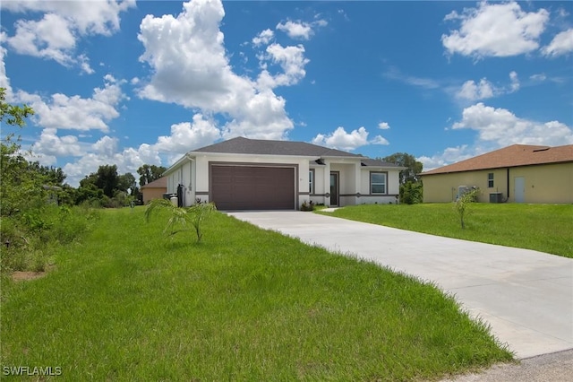311 Rand Ave, Lehigh Acres, FL 33974 - ranch-style house with stucco siding, an attached garage, concrete driveway, and a front yard