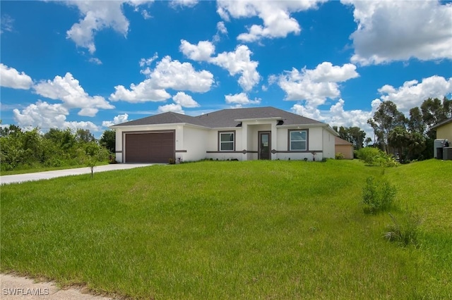311 Rand Ave, Lehigh Acres, FL 33974 - ranch-style house with stucco siding, driveway, an attached garage, and a front yard