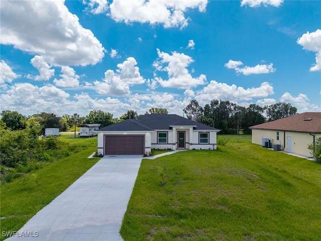 311 Rand Ave, Lehigh Acres, FL 33974 - view of front of property featuring an attached garage, concrete driveway, a front lawn, and stucco siding