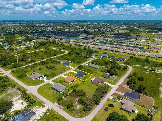 311 Rand Ave, Lehigh Acres, FL 33974 - aerial perspective of suburban area with a large body of water