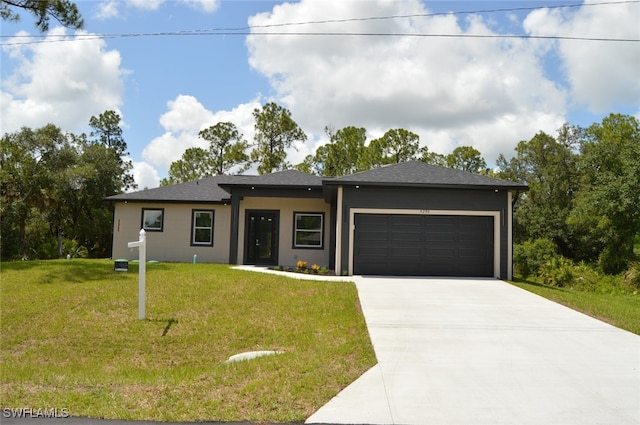 4204 E 24th St, Alva, FL 33920 - prairie-style home featuring a garage, driveway, a front lawn, stucco siding, and a shingled roof