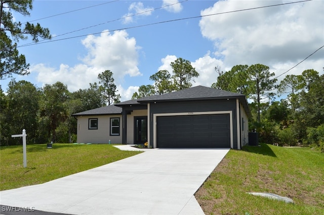 4204 E 24th St, Alva, FL 33920 - view of front of property featuring concrete driveway, an attached garage, a front lawn, and stucco siding