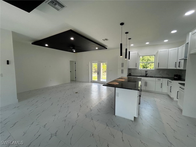 4204 E 24th St, Alva, FL 33920 - kitchen featuring dark countertops, open floor plan, recessed lighting, french doors, and decorative backsplash