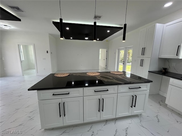 4204 E 24th St, Alva, FL 33920 - kitchen with light marble finish flooring, dark countertops, french doors, and white cabinetry