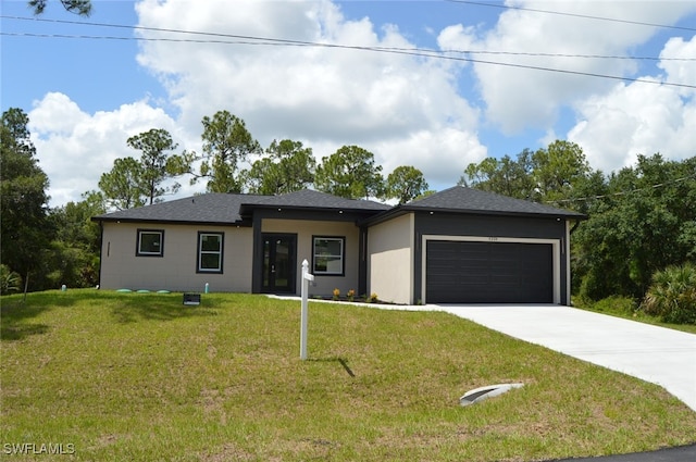 4204 E 24th St, Alva, FL 33920 - prairie-style house with concrete driveway, an attached garage, a front lawn, and a shingled roof