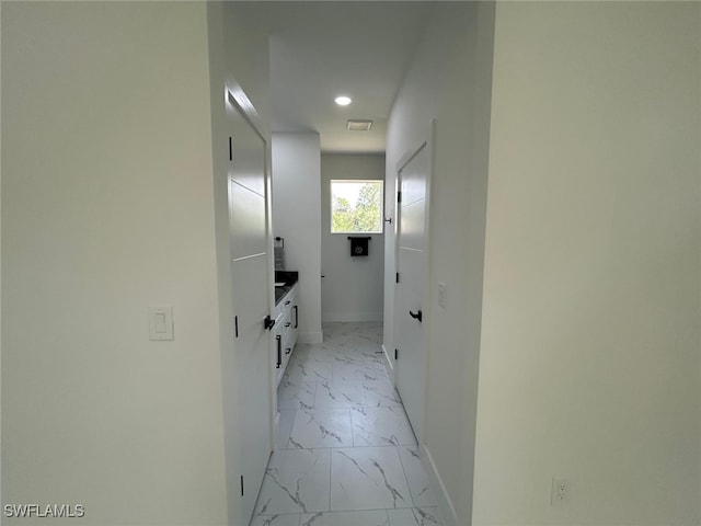 4204 E 24th St, Alva, FL 33920 - hallway featuring light marble finish floors and recessed lighting