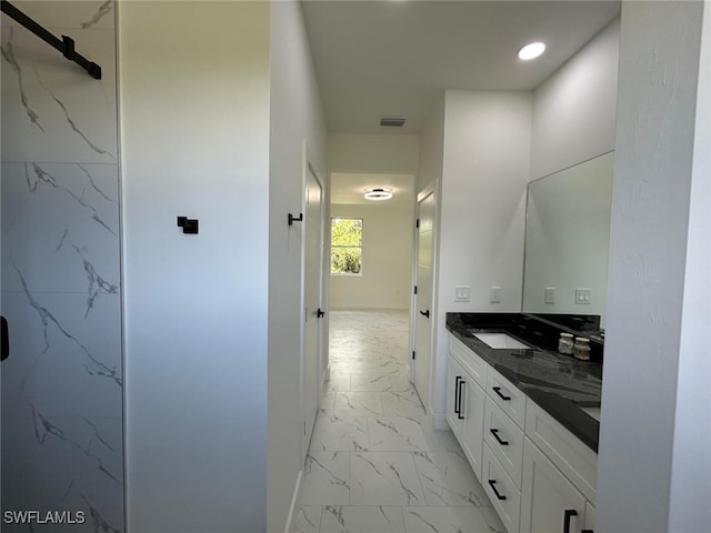 4204 E 24th St, Alva, FL 33920 - bathroom featuring marble look tile flooring, double vanity, and recessed lighting