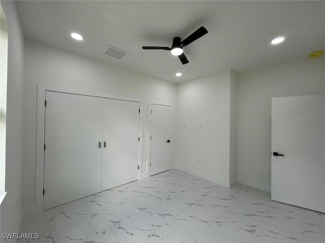 4204 E 24th St, Alva, FL 33920 - unfurnished bedroom featuring recessed lighting, light marble finish floors, ceiling fan, and a closet