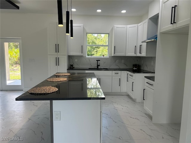 4204 E 24th St, Alva, FL 33920 - kitchen featuring dark countertops, healthy amount of natural light, light marble finish floors, and recessed lighting