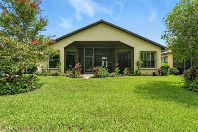 23484 Sanabria Loop, Bonita Springs, FL 34135 - rear view of property with stucco siding, a yard, and a sunroom