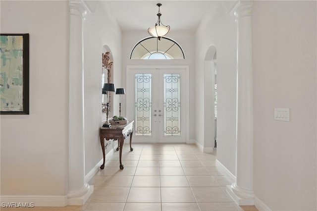 23484 Sanabria Loop, Bonita Springs, FL 34135 - foyer with arched walkways, light tile patterned floors, and french doors