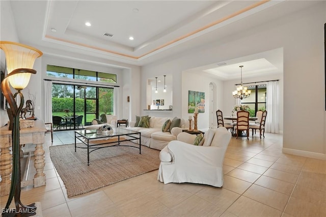 23484 Sanabria Loop, Bonita Springs, FL 34135 - living room with a tray ceiling, light tile patterned floors, a chandelier, and recessed lighting