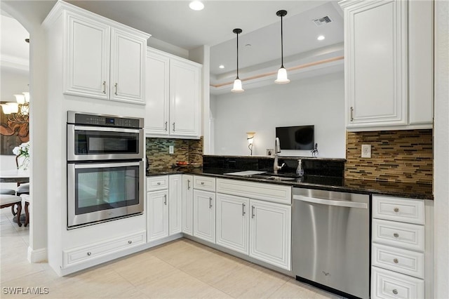 23484 Sanabria Loop, Bonita Springs, FL 34135 - kitchen with stainless steel appliances, decorative backsplash, white cabinetry, recessed lighting, and decorative light fixtures