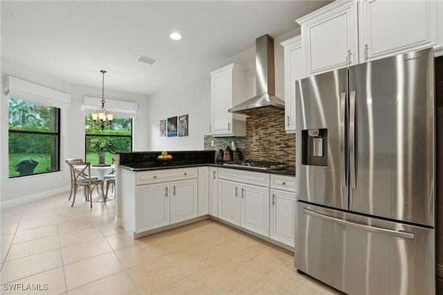 23484 Sanabria Loop, Bonita Springs, FL 34135 - kitchen featuring stainless steel appliances, wall chimney exhaust hood, dark countertops, a peninsula, and recessed lighting