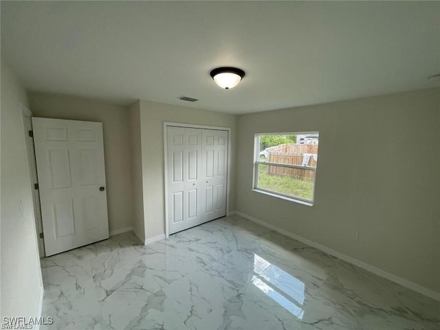 4605/4607 30th St SW, Lehigh Acres, FL 33973 - unfurnished bedroom with marble look tiles and a closet