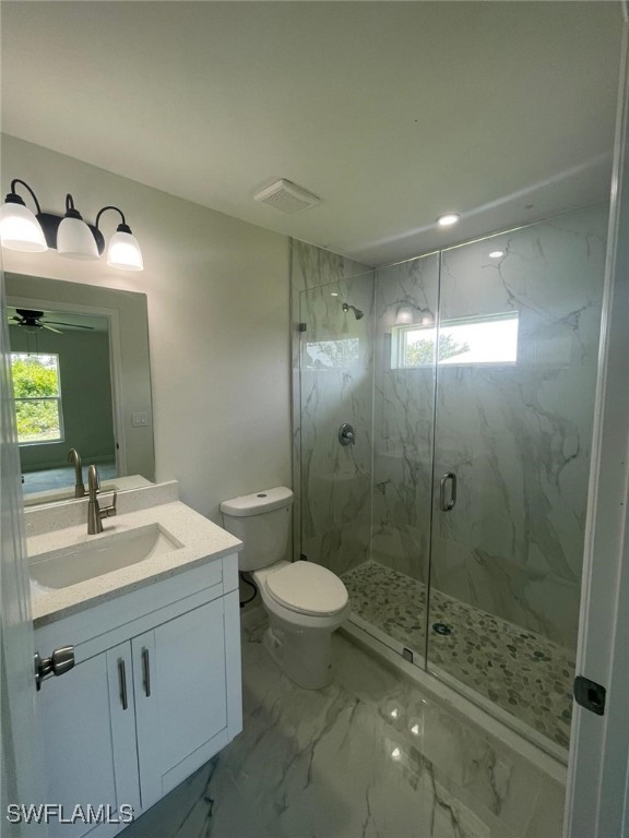 1112/1114 Ivan Ave S, Lehigh Acres, FL 33973 - full bath with marble finish floors, a marble finish shower, vanity, and ceiling fan