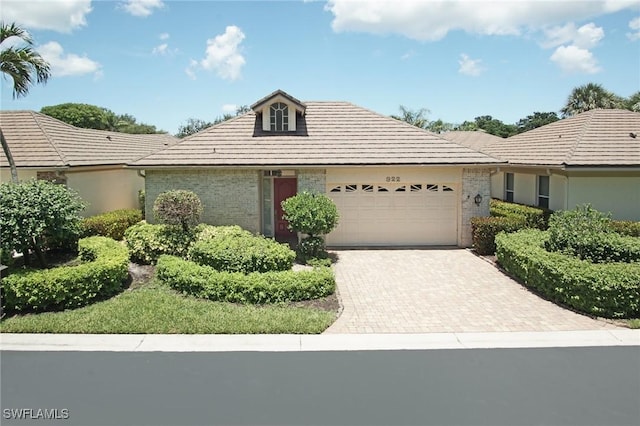 922 Turtle Ct Unit 21-21, Naples, FL 34108 - ranch-style house with brick siding, a garage, and driveway