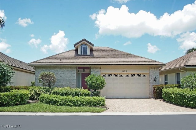 922 Turtle Ct Unit 21-21, Naples, FL 34108 - ranch-style home featuring brick siding, an attached garage, and driveway