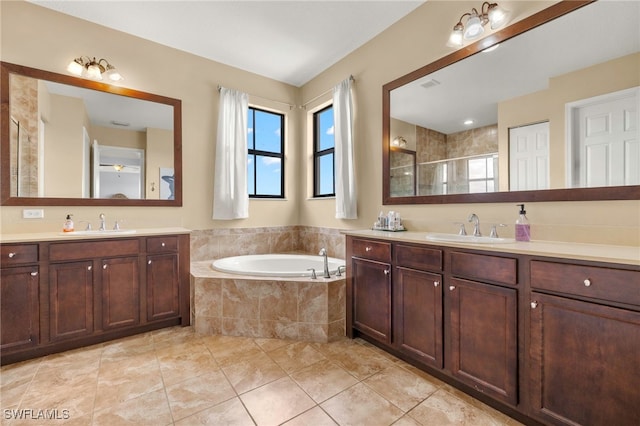 5158 Roma St, Ave Maria, FL 34142 - bathroom featuring two vanities, a garden tub, a tile shower, and tile patterned flooring