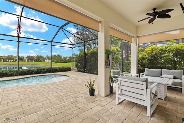 5158 Roma St, Ave Maria, FL 34142 - view of patio with outdoor lounge area, a ceiling fan, an outdoor pool, a water view, and glass enclosure