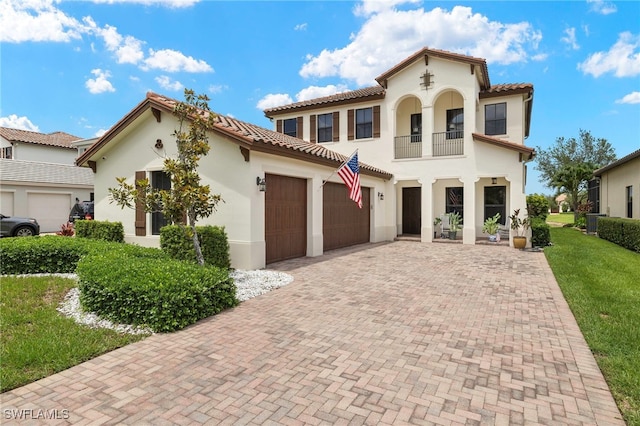 5158 Roma St, Ave Maria, FL 34142 - mediterranean / spanish-style house featuring a garage, decorative driveway, a balcony, stucco siding, and a front yard