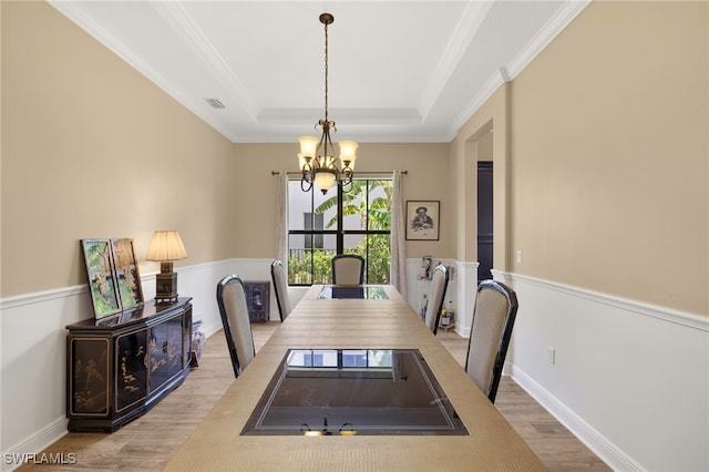5158 Roma St, Ave Maria, FL 34142 - dining space featuring a chandelier, wood finished floors, ornamental molding, and a raised ceiling