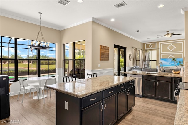 5158 Roma St, Ave Maria, FL 34142 - kitchen featuring dishwasher, ceiling fan, a kitchen island, crown molding, and light wood finished floors