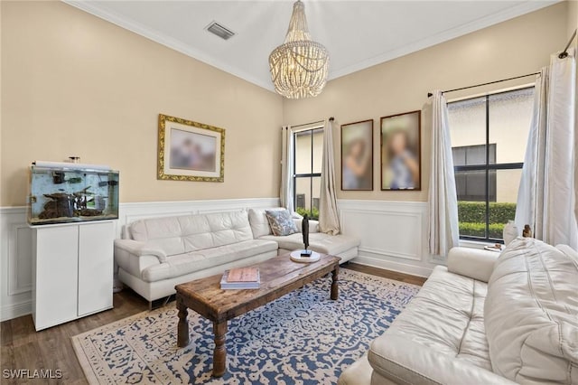 5158 Roma St, Ave Maria, FL 34142 - living area with a chandelier, wood finished floors, a wainscoted wall, and crown molding