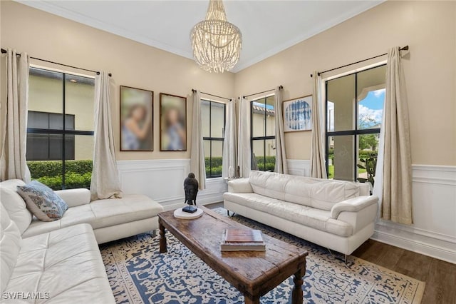 5158 Roma St, Ave Maria, FL 34142 - living area with a chandelier, healthy amount of natural light, wainscoting, wood finished floors, and crown molding