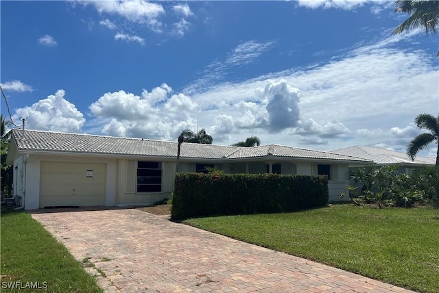 3 Palmview Blvd, Fort Myers Beach, FL 33931 - ranch-style home featuring a garage, a tiled roof, decorative driveway, and a front yard