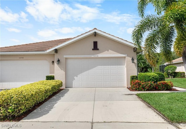 10736 Cetrella Dr, Fort Myers, FL 33913 - view of front of home featuring stucco siding, driveway, and a tiled roof
