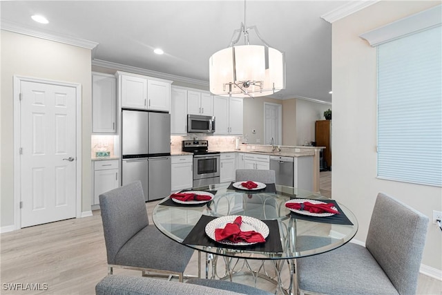 10736 Cetrella Dr, Fort Myers, FL 33913 - dining room featuring crown molding, recessed lighting, light wood-style floors, and a chandelier