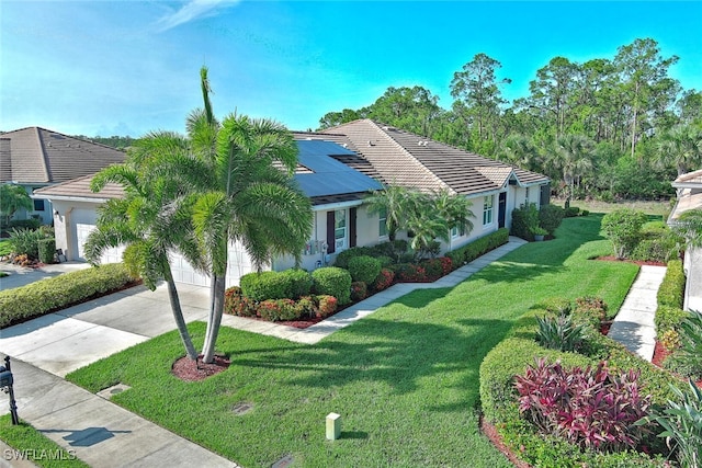 10736 Cetrella Dr, Fort Myers, FL 33913 - view of front of home featuring driveway, an attached garage, a tiled roof, a front yard, and stucco siding