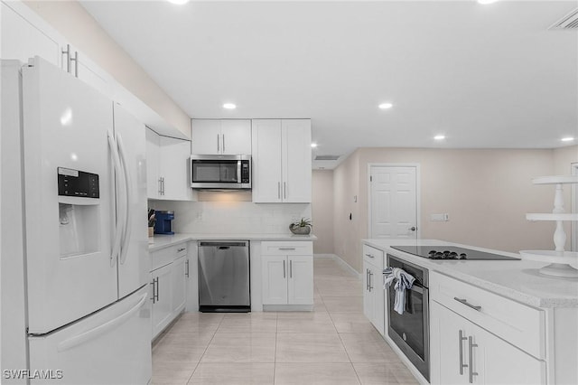 3823 Palm Tree Blvd, Cape Coral, FL 33904 - kitchen with appliances with stainless steel finishes, white cabinetry, recessed lighting, tasteful backsplash, and light tile patterned flooring