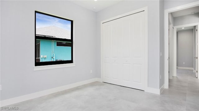 739 David Laird Ln, Lehigh Acres, FL 33974 - unfurnished bedroom featuring concrete floors and a closet