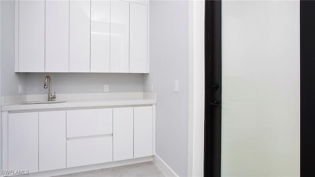 739 David Laird Ln, Lehigh Acres, FL 33974 - kitchen with light countertops, modern cabinets, and white cabinetry