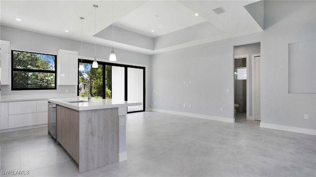 739 David Laird Ln, Lehigh Acres, FL 33974 - kitchen featuring modern cabinets, white cabinetry, light countertops, a center island with sink, and hanging light fixtures