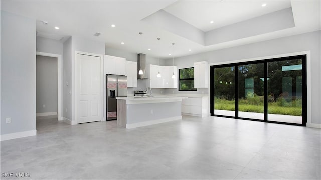 739 David Laird Ln, Lehigh Acres, FL 33974 - kitchen featuring appliances with stainless steel finishes, a center island with sink, white cabinets, light countertops, and wall chimney exhaust hood