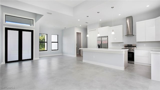 739 David Laird Ln, Lehigh Acres, FL 33974 - kitchen featuring appliances with stainless steel finishes, wall chimney range hood, modern cabinets, white cabinetry, and decorative light fixtures
