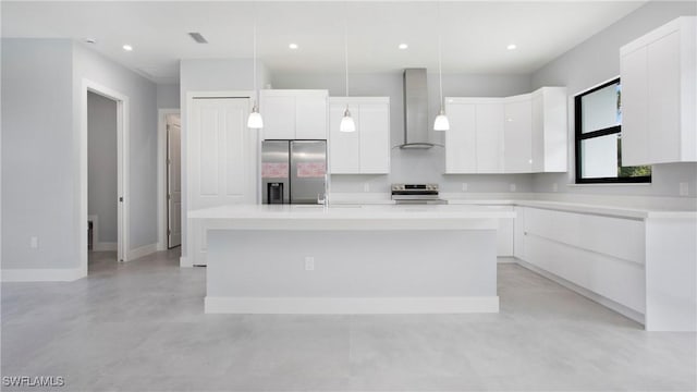 739 David Laird Ln, Lehigh Acres, FL 33974 - kitchen with wall chimney exhaust hood, appliances with stainless steel finishes, finished concrete flooring, white cabinetry, and a kitchen island with sink
