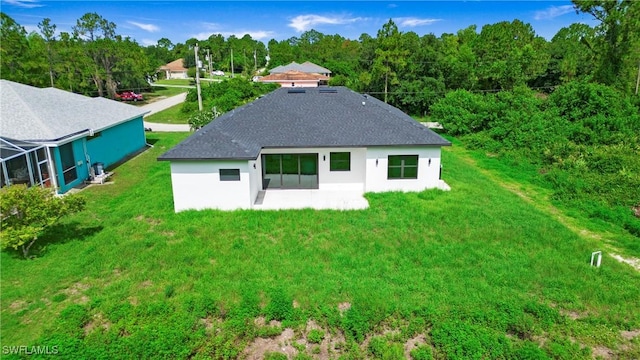 739 David Laird Ln, Lehigh Acres, FL 33974 - back of property with a patio, stucco siding, a lawn, a wooded view, and a shingled roof